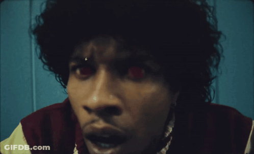 A Close Up Of A Person 'S Face With Red Eyes GIF