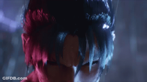 A Close Up Of A Person 'S Face With Red Hair And Blue Hair GIF