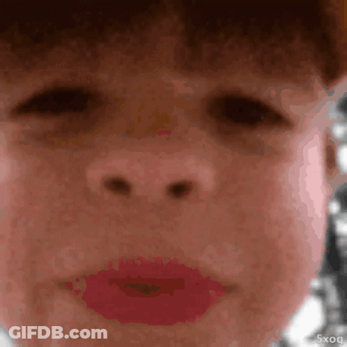 A Close Up Of A Person 'S Face With Red Lipstick And The Letters 5Xq On The Bottom Right GIF