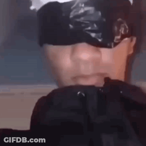 A Close Up Of A Person 'S Face With Tape On It . GIF