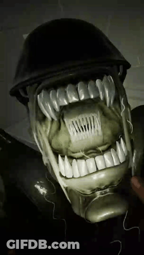 A Close Up Of A Person 'S Face With Teeth And A Helmet On It GIF