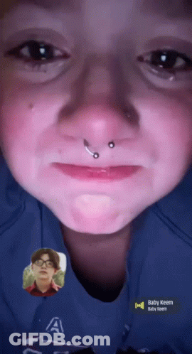 A Close Up Of A Person 'S Face With The Name Baby Keem On The Bottom GIF
