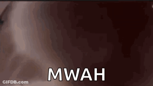 A Close Up Of A Person 'S Face With The Word Mwah On It GIF
