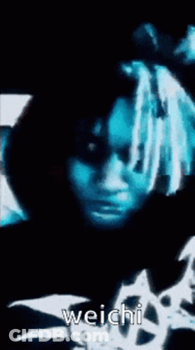 A Close Up Of A Person 'S Face With The Word Weichi On The Bottom Right GIF