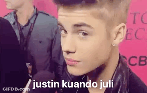 A Close Up Of A Person 'S Face With The Words `` Justin Kuando Juli '' Written On The Bottom . GIF