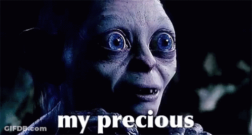 A Close Up Of A Person 'S Face With The Words `` My Precious '' Written Below It . GIF