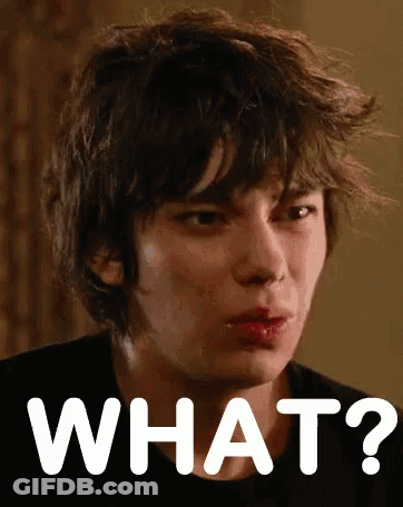A Close Up Of A Person 'S Face With The Words What Written In White GIF