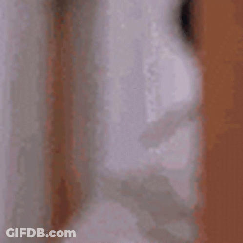 A Close Up Of A Person 'S Face With Their Eyes Closed And A Blurred Background . GIF