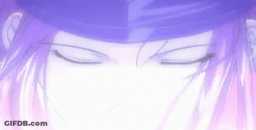 A Close Up Of A Person 'S Face With Their Eyes Closed And A Purple Hat On . GIF