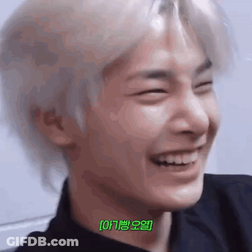 A Close Up Of A Person 'S Face With Their Eyes Closed And A Smile On Their Face . GIF
