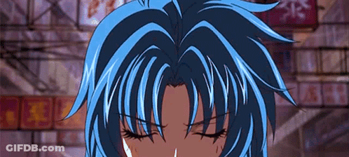 A Close Up Of A Person 'S Face With Their Eyes Closed And Blue Hair . GIF