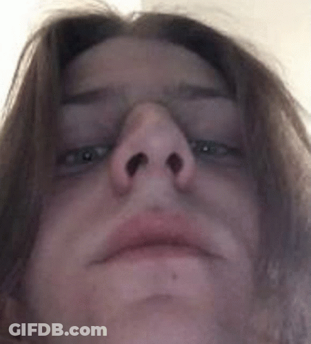 A Close Up Of A Person 'S Face With Their Eyes Closed And Their Nose Visible . GIF