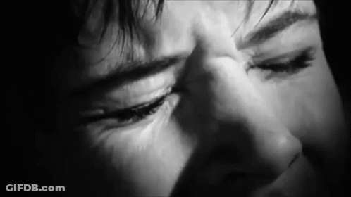 A Close Up Of A Person 'S Face With Their Eyes Closed . GIF