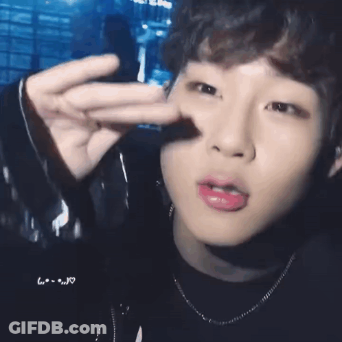 A Close Up Of A Person 'S Face With Their Finger In Their Nose . GIF