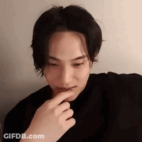 A Close Up Of A Person 'S Face With Their Finger On Their Mouth . GIF