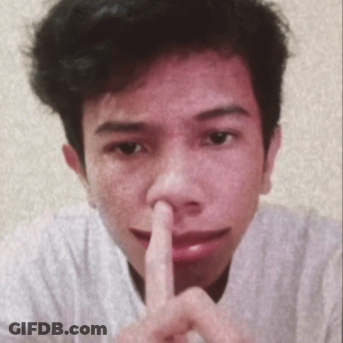 A Close Up Of A Person 'S Face With Their Finger On Their Nose GIF