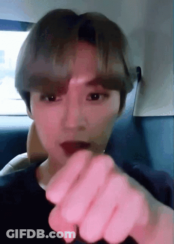 A Close Up Of A Person 'S Face With Their Finger Pointing To The Camera GIF