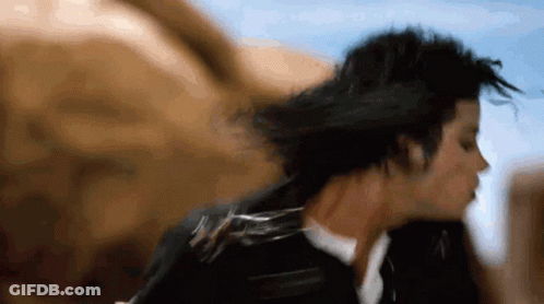 A Close Up Of A Person 'S Face With Their Hair Blowing In The Wind GIF