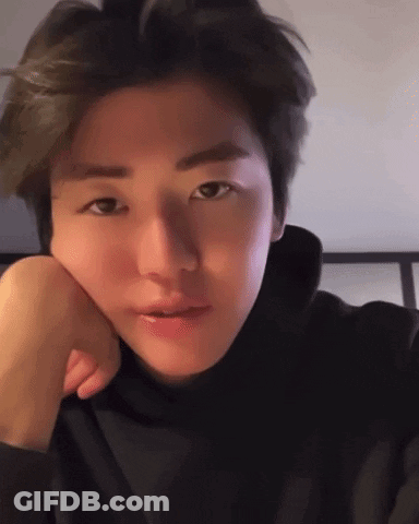 A Close Up Of A Person 'S Face With Their Hand On Their Face . GIF