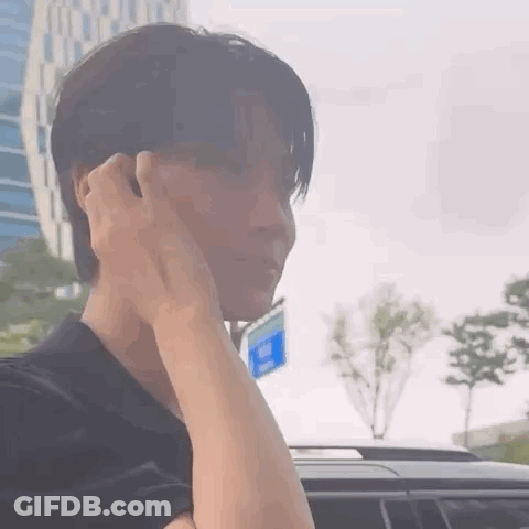 A Close Up Of A Person 'S Face With Their Hand On Their Face . GIF
