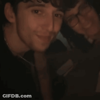 A Close Up Of A Person 'S Face With Their Hand Up GIF