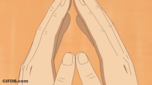 A Close Up Of A Person 'S Face With Their Hands Folded GIF