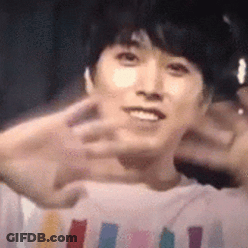 A Close Up Of A Person 'S Face With Their Hands In The Air . GIF