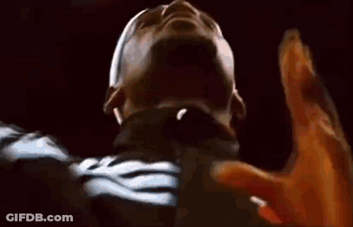 A Close Up Of A Person 'S Face With Their Hands Up In The Air . GIF