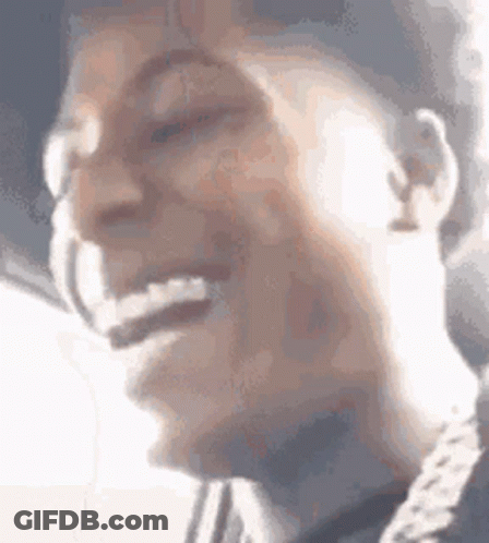 A Close Up Of A Person 'S Face With Their Mouth Open And A Chain Around Their Neck . GIF
