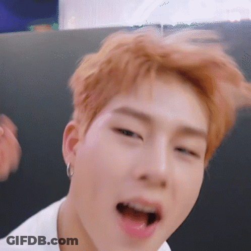 A Close Up Of A Person 'S Face With Their Mouth Open And Earrings . GIF