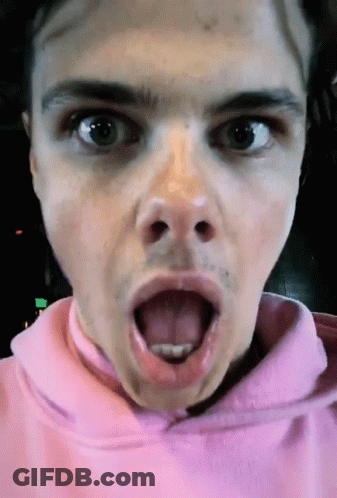 A Close Up Of A Person 'S Face With Their Tongue Out GIF