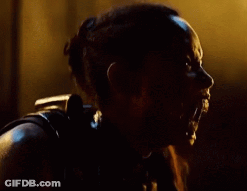 A Close Up Of A Person 'S Face With Water Coming Out Of It In The Dark . GIF