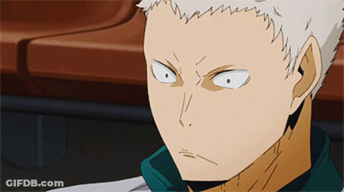 A Close Up Of A Person 'S Face With White Hair And A Green Shirt GIF
