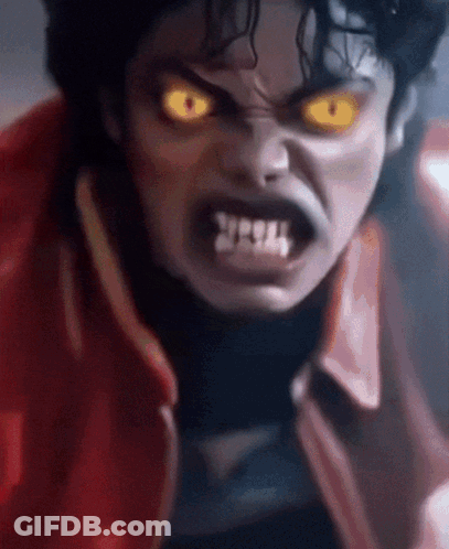 A Close Up Of A Person 'S Face With Yellow Eyes And Teeth GIF