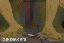 A Close Up Of A Person 'S Feet Standing On A Dirty Floor . GIF