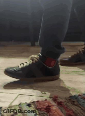 A Close Up Of A Person 'S Feet Wearing Black Shoes GIF