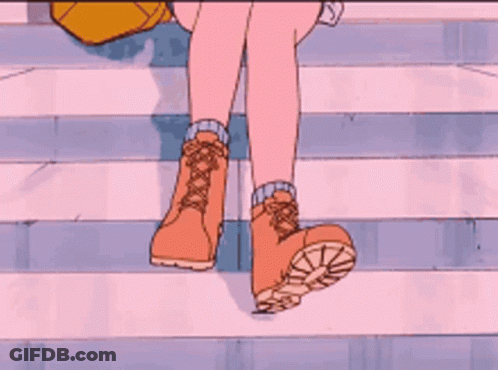 A Close Up Of A Person 'S Feet Wearing Brown Boots GIF