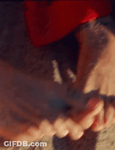 A Close Up Of A Person 'S Feet With Red Nail Polish On Them GIF