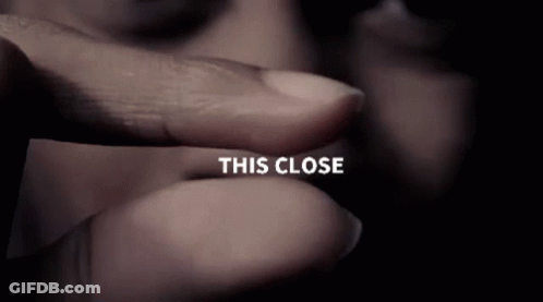 A Close Up Of A Person 'S Finger With The Words This Close Visible GIF