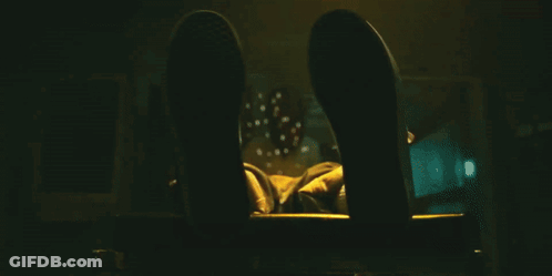 A Close Up Of A Person 'S Fist With A Yellow Light Behind It GIF