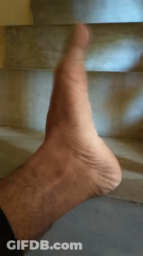 A Close Up Of A Person 'S Foot Against A Staircase GIF