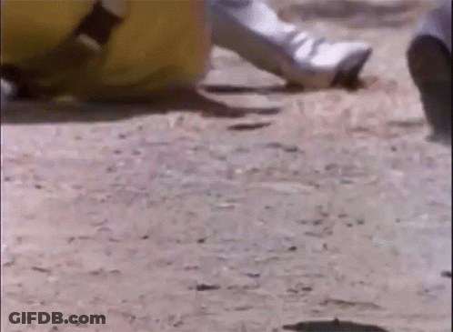 A Close Up Of A Person 'S Foot On A Dirt Road . GIF