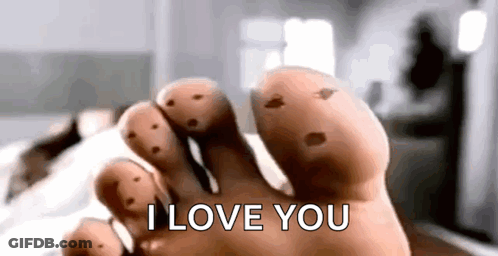 A Close Up Of A Person 'S Foot With Holes In It And The Words `` I Love You '' . GIF