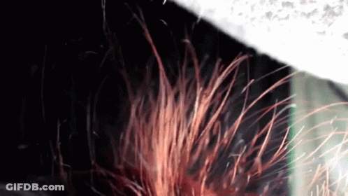 A Close Up Of A Person 'S Hair Being Blown By A Fan GIF