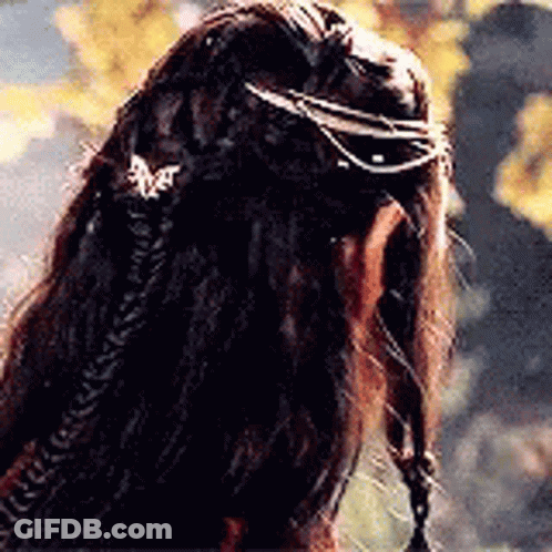 A Close Up Of A Person 'S Hair With A Braid And A Ring On It . GIF