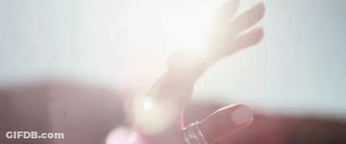 A Close Up Of A Person 'S Hand Holding A Bottle Of Water . GIF