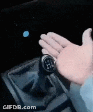 A Close Up Of A Person 'S Hand Holding A Gear Shifter GIF