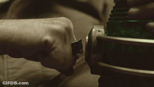 A Close Up Of A Person 'S Hand Holding A Green Lighted Object GIF