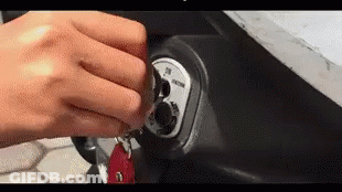A Close Up Of A Person 'S Hand Holding A Key . GIF