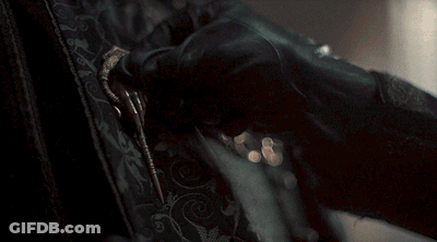 A Close Up Of A Person 'S Hand Holding A Key GIF